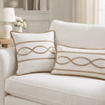 White armchair with decorative pillows in a living room setting