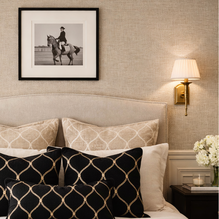 Neatly made bed with decorative pillows in a bedroom setting.